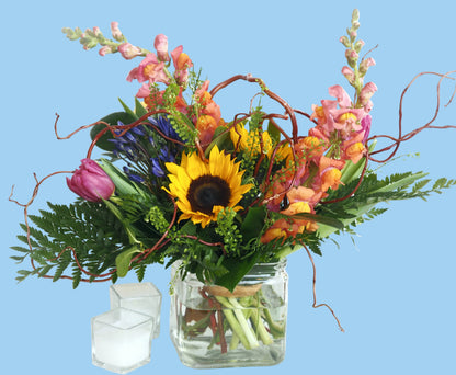 Colorful flower arrangement in a glass vase on a white background